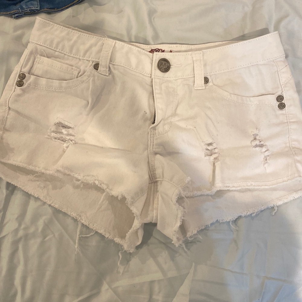 White shorts small stains on back pockets